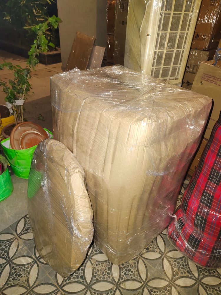 Cabinet wrapped and staged near the entrance before a move